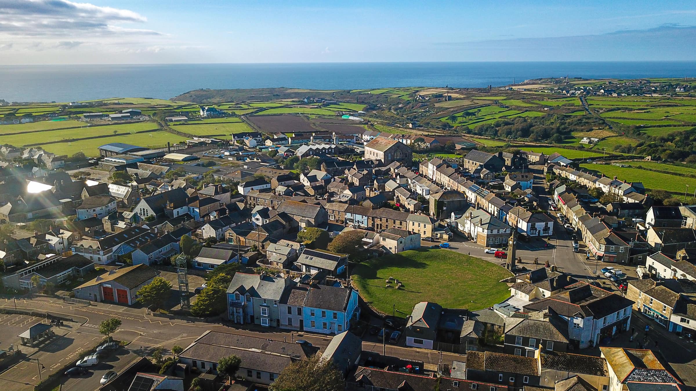 Aerial view of St Just with Tredenwith House's terrace facing the Plain-an-Gwarry green, Cape Cornwall and the Atlantic beyond