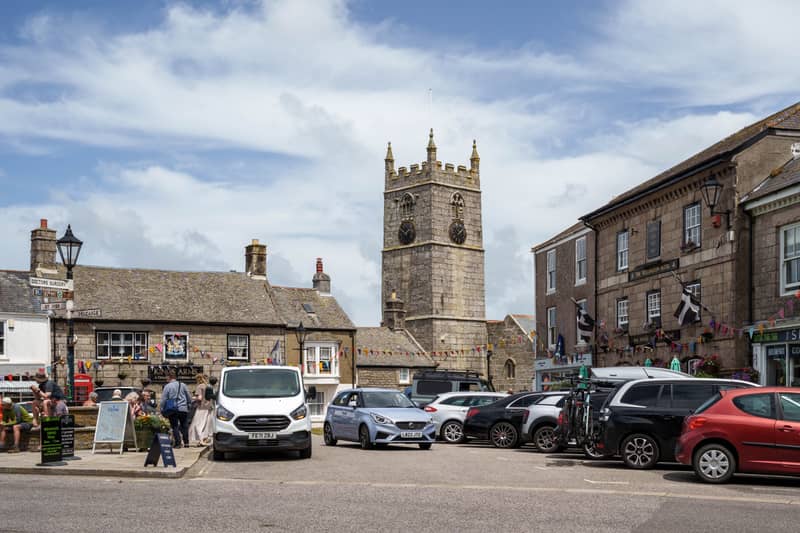 St Just town square with the church tower, Kings Arms pub and bunting