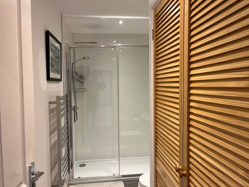 Bathroom with large walk-in shower and towel rail
