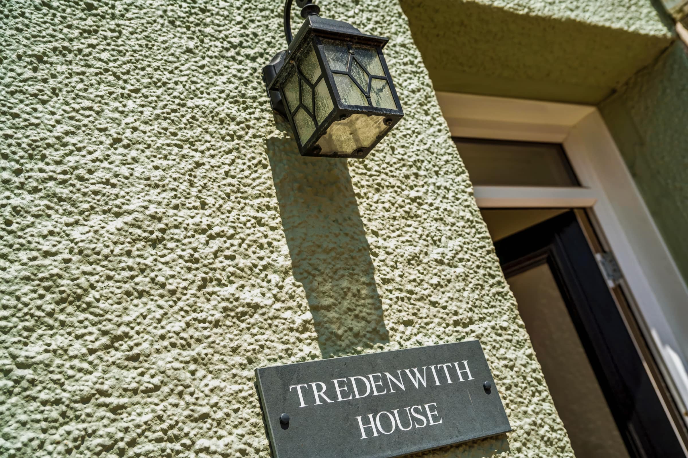 The slate Tredenwith House name plaque and lantern beside the front door