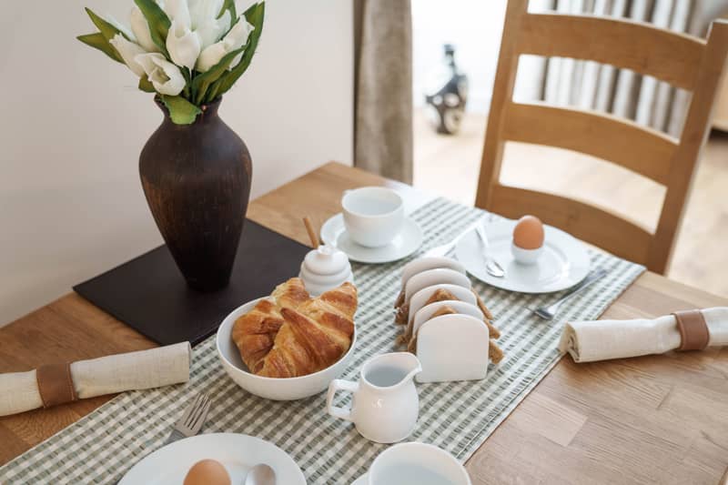 Croissants, toast and boiled eggs on the dining table
